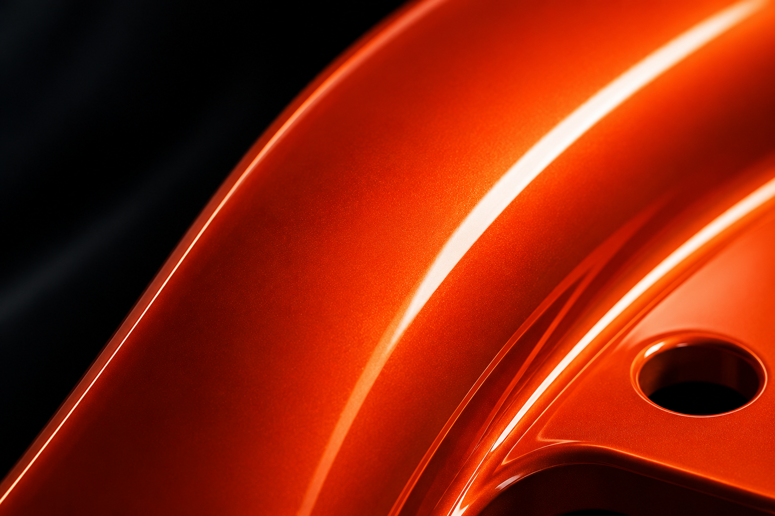 Gloss orange metallic finish on a wheel rim