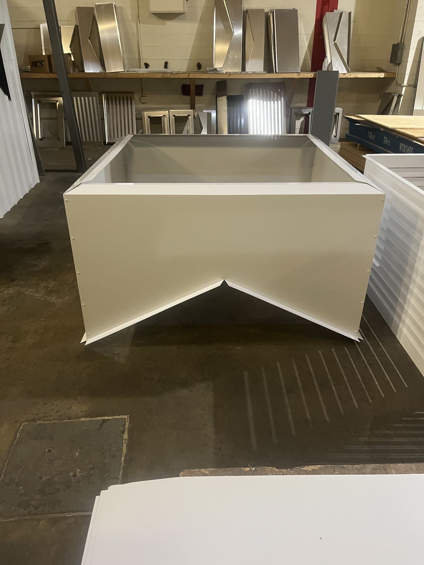 A custom hood-shaped enclosure, fabricated and finished in cream powder coat