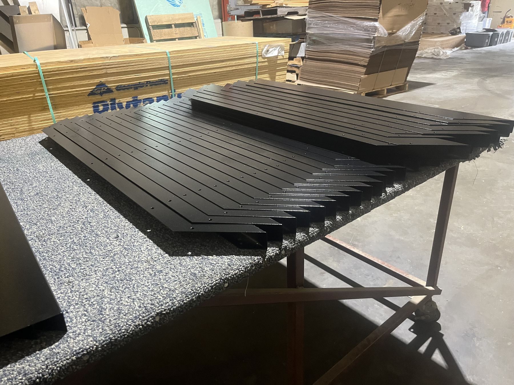 Freshly finished diamond-plate panels laid out in the shop
